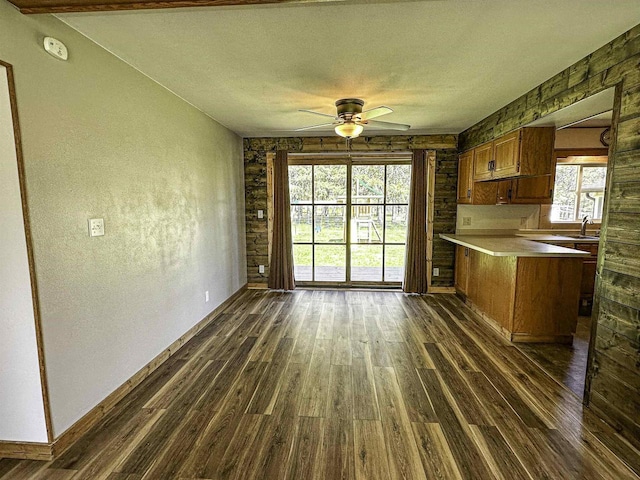 1200 4th Ave N, Park Falls, WI 54552 - kitchen featuring dark wood-style floors, a ceiling fan, a peninsula, brown cabinetry, and light countertops