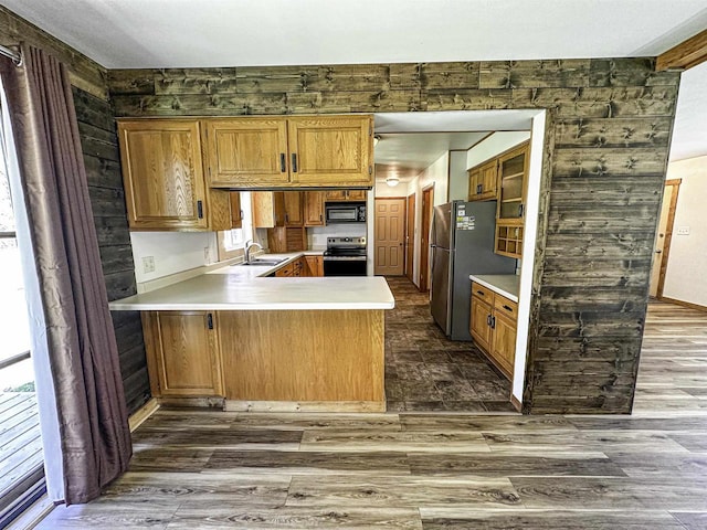 1200 4th Ave N, Park Falls, WI 54552 - kitchen with appliances with stainless steel finishes, a peninsula, light countertops, and dark wood-style flooring