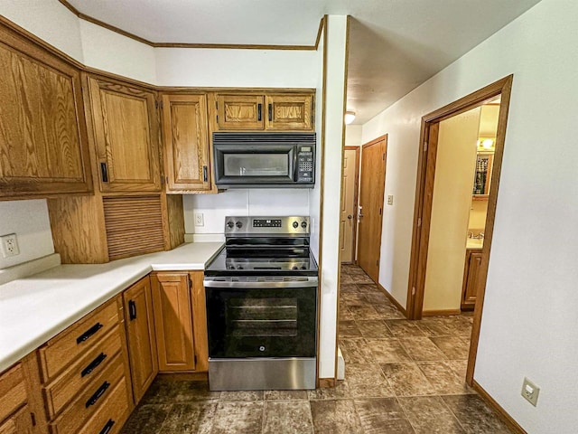 1200 4th Ave N, Park Falls, WI 54552 - kitchen featuring electric range, black microwave, brown cabinets, light countertops, and baseboards