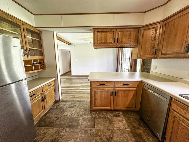 1200 4th Ave N, Park Falls, WI 54552 - kitchen with stainless steel appliances, brown cabinetry, a peninsula, light countertops, and crown molding