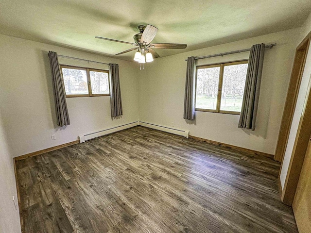 1200 4th Ave N, Park Falls, WI 54552 - empty room featuring dark wood-type flooring, baseboard heating, a ceiling fan, and baseboards