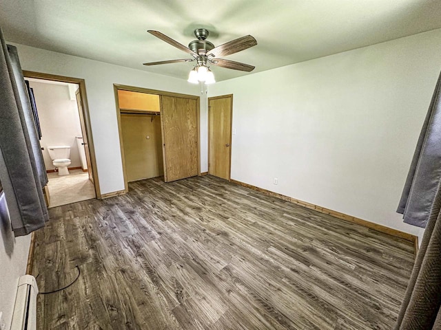 1200 4th Ave N, Park Falls, WI 54552 - unfurnished bedroom featuring dark wood finished floors, baseboards, ceiling fan, a closet, and connected bathroom