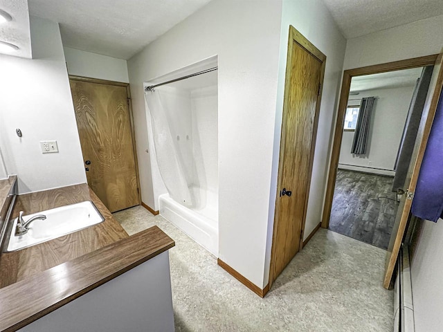 1200 4th Ave N, Park Falls, WI 54552 - full bath featuring a baseboard radiator, vanity, baseboards, shower / tub combination, and a textured ceiling