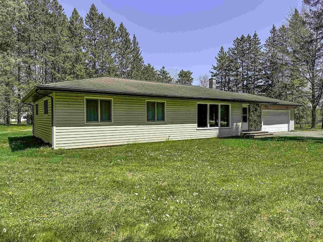 1200 4th Ave N, Park Falls, WI 54552 - view of front of house featuring an attached garage, a front yard, and a chimney
