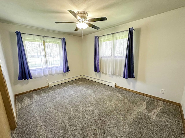 1200 4th Ave N, Park Falls, WI 54552 - carpeted spare room featuring plenty of natural light, ceiling fan, baseboards, and a baseboard heating unit