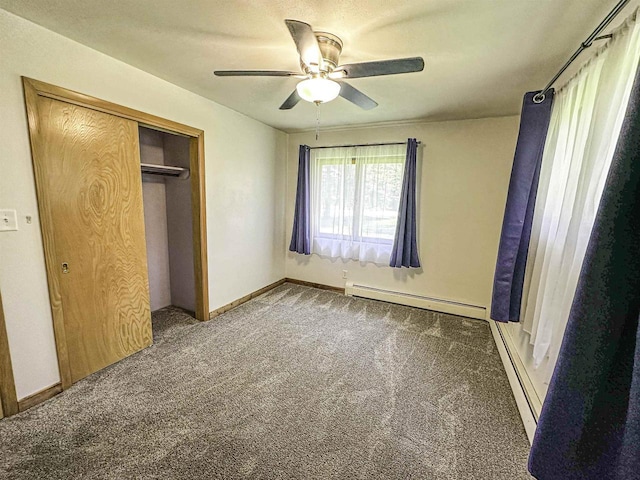 1200 4th Ave N, Park Falls, WI 54552 - unfurnished bedroom featuring a baseboard radiator, carpet flooring, a closet, and baseboards