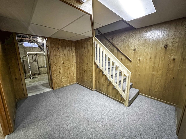 1200 4th Ave N, Park Falls, WI 54552 - finished below grade area featuring carpet flooring, a drop ceiling, wooden walls, stairway, and baseboards
