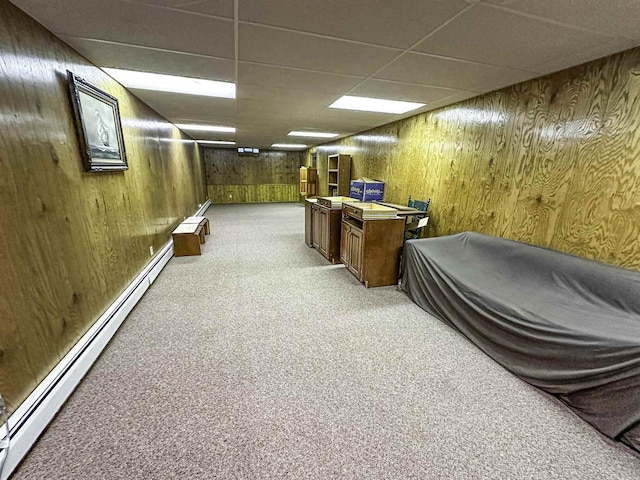 1200 4th Ave N, Park Falls, WI 54552 - finished below grade area featuring light colored carpet, baseboard heating, a drop ceiling, and wooden walls