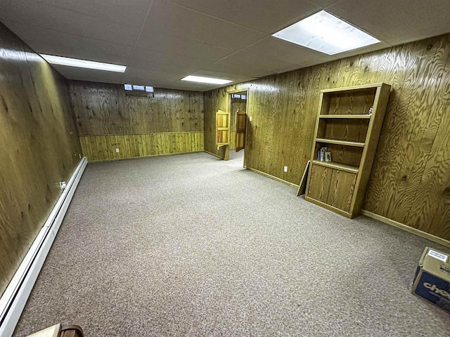 1200 4th Ave N, Park Falls, WI 54552 - finished basement featuring baseboard heating, carpet flooring, wooden walls, a paneled ceiling, and baseboards