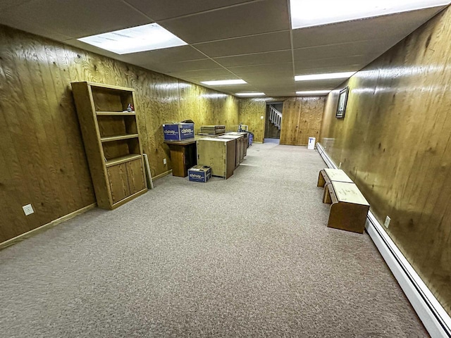 1200 4th Ave N, Park Falls, WI 54552 - finished basement with a baseboard radiator, a drop ceiling, light carpet, and wood walls