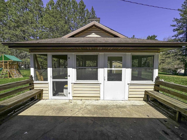 1200 4th Ave N, Park Falls, WI 54552 - rear view of house with a playground, a chimney, and a shingled roof