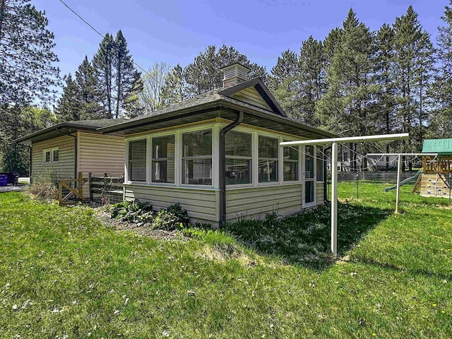 1200 4th Ave N, Park Falls, WI 54552 - view of side of property with a playground and a chimney