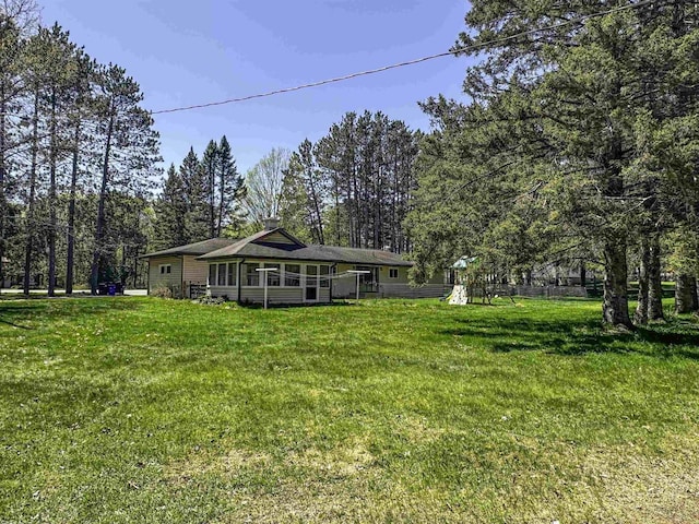 1200 4th Ave N, Park Falls, WI 54552 - rear view of house featuring a lawn and a sunroom