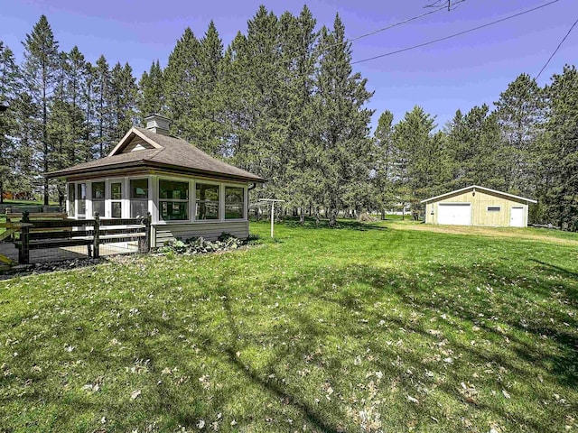 1200 4th Ave N, Park Falls, WI 54552 - view of grassy yard with a detached garage and an outdoor structure