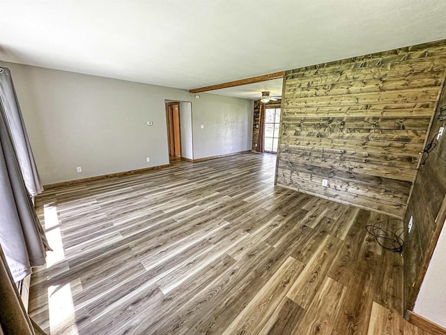 1200 4th Ave N, Park Falls, WI 54552 - empty room with wood finished floors, ceiling fan, wood walls, and baseboards