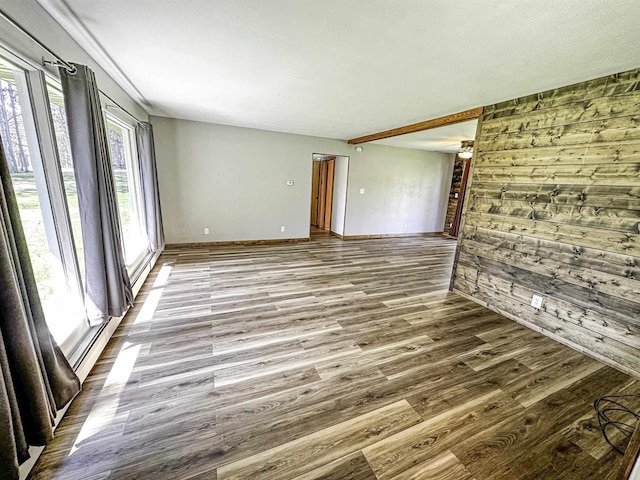 1200 4th Ave N, Park Falls, WI 54552 - empty room featuring wood walls, wood finished floors, and baseboards