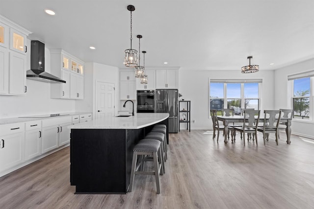 1150 S Bay Shore Rd, Brussels, WI 54204 - kitchen featuring wall chimney range hood, black appliances, a chandelier, a sink, and white cabinets