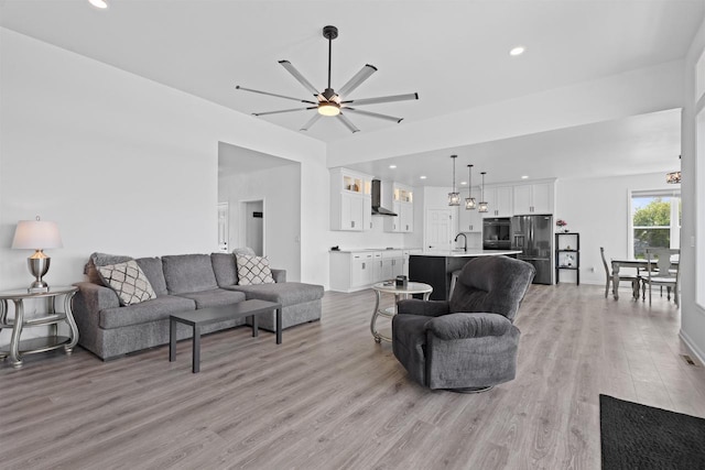 1150 S Bay Shore Rd, Brussels, WI 54204 - living room with light wood-style flooring, ceiling fan, recessed lighting, and a chandelier