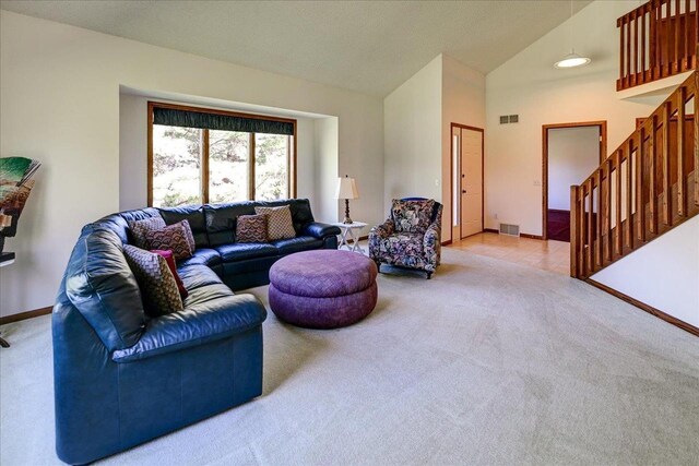 6460 Shady Bend Rd, Verona, WI 53593 - living room featuring light carpet, high vaulted ceiling, baseboards, and stairs