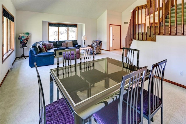 6460 Shady Bend Rd, Verona, WI 53593 - carpeted dining area featuring baseboards, stairs, and lofted ceiling