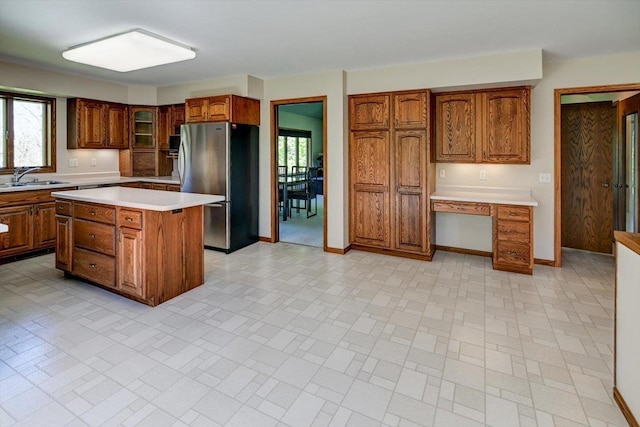6460 Shady Bend Rd, Verona, WI 53593 - kitchen featuring freestanding refrigerator, a sink, light countertops, brown cabinetry, and healthy amount of natural light