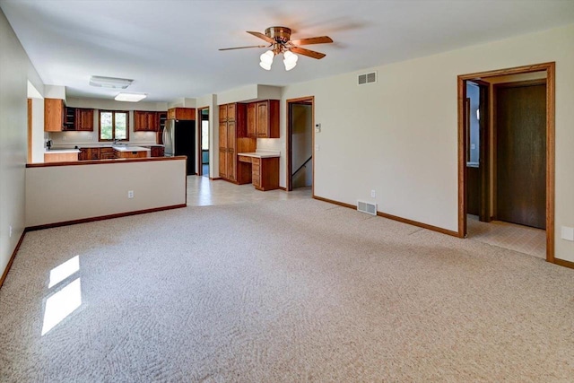 6460 Shady Bend Rd, Verona, WI 53593 - unfurnished living room with a ceiling fan, baseboards, and light colored carpet