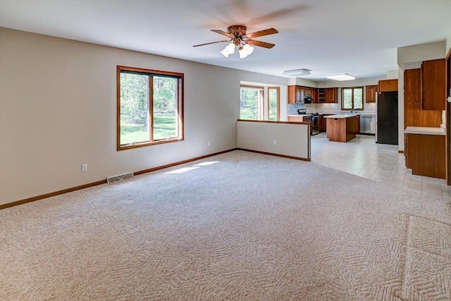 6460 Shady Bend Rd, Verona, WI 53593 - unfurnished living room featuring ceiling fan, baseboards, and light carpet