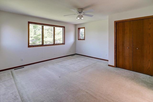 6460 Shady Bend Rd, Verona, WI 53593 - unfurnished bedroom with light carpet, baseboards, a closet, and a ceiling fan
