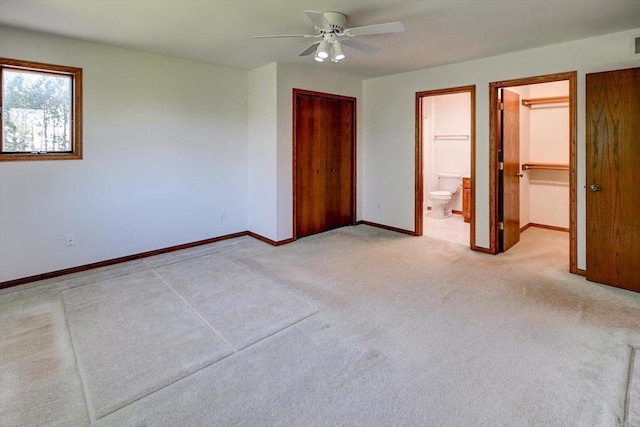 6460 Shady Bend Rd, Verona, WI 53593 - unfurnished bedroom with light colored carpet, baseboards, a closet, ensuite bath, and ceiling fan