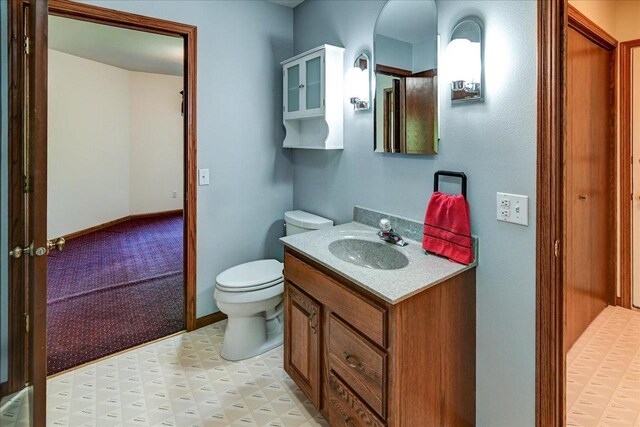 6460 Shady Bend Rd, Verona, WI 53593 - half bathroom featuring toilet, vanity, and tile patterned floors