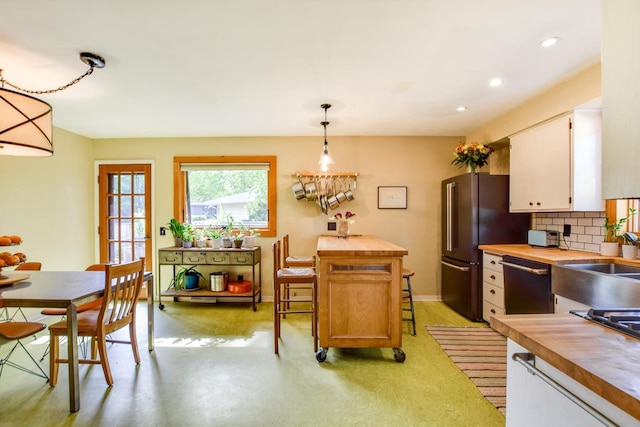 5102 Marathon Dr, Madison, WI 53705 - kitchen featuring butcher block countertops, dishwashing machine, backsplash, white cabinets, and recessed lighting