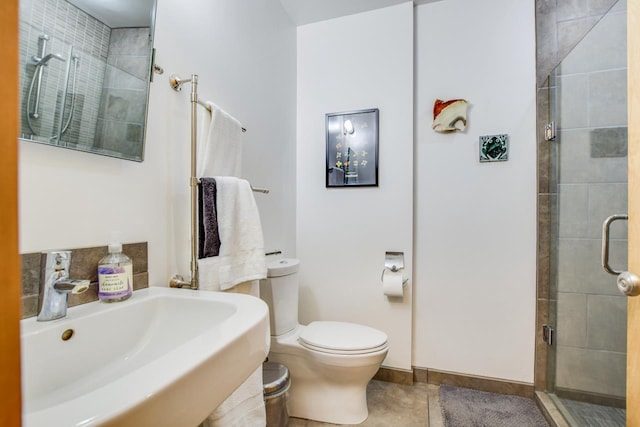 5102 Marathon Dr, Madison, WI 53705 - full bathroom featuring a stall shower, a sink, toilet, tile patterned floors, and baseboards