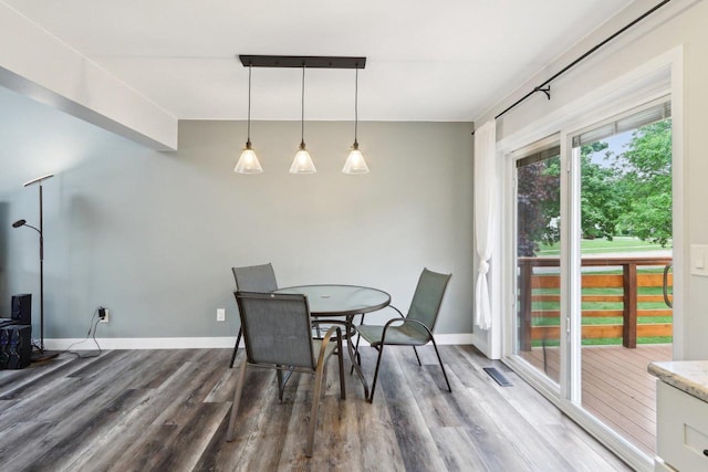 1902 Winfield Dr, Reedsburg, WI 53959 - dining space with wood finished floors, baseboards, and a wood stove