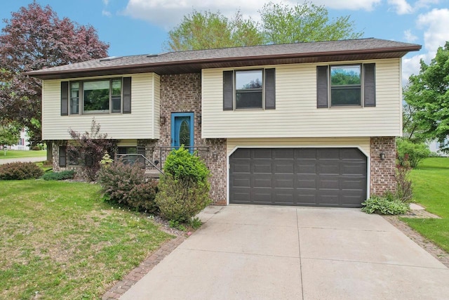 1902 Winfield Dr, Reedsburg, WI 53959 - bi-level home featuring an attached garage, brick siding, a front yard, and concrete driveway