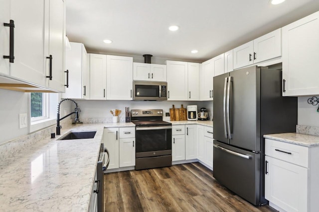 1902 Winfield Dr, Reedsburg, WI 53959 - kitchen with stainless steel appliances, a sink, white cabinetry, recessed lighting, and light stone counters