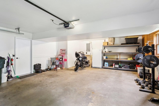 1902 Winfield Dr, Reedsburg, WI 53959 - garage featuring a garage door opener, freestanding refrigerator, and electric panel