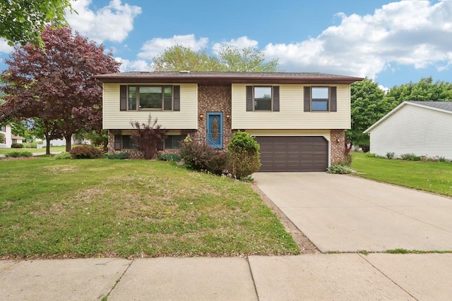 1902 Winfield Dr, Reedsburg, WI 53959 - raised ranch with an attached garage, driveway, a front yard, and brick siding