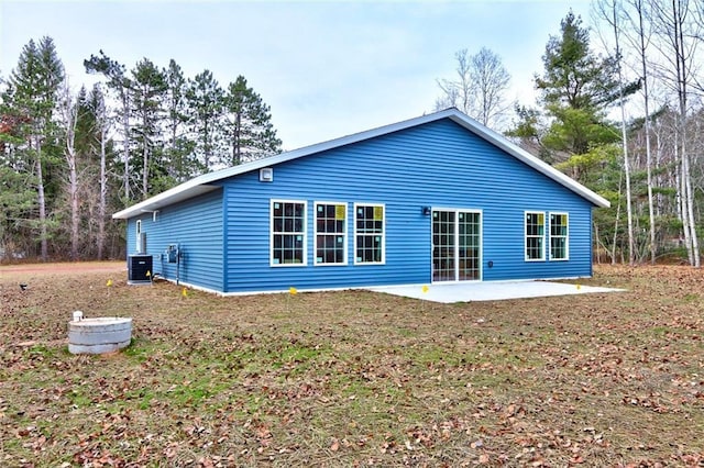 10246 Olker Rd, Hayward, WI 54843 - rear view of house with a patio and a yard