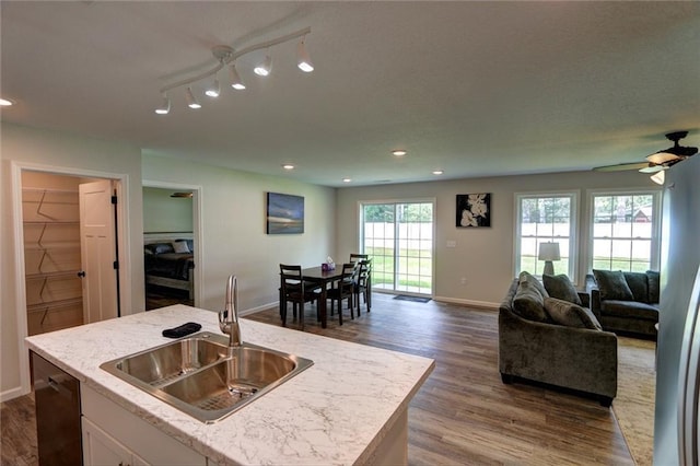 10246 Olker Rd, Hayward, WI 54843 - kitchen featuring open floor plan, dark wood-type flooring, a center island with sink, white cabinets, and recessed lighting