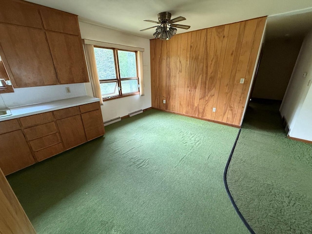 W12574 US Highway 45, Marion, WI 54950 - kitchen with brown cabinets, a baseboard radiator, ceiling fan, light countertops, and carpet flooring