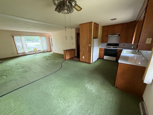 W12574 US Highway 45, Marion, WI 54950 - kitchen featuring white appliances, under cabinet range hood, brown cabinets, open floor plan, and ceiling fan