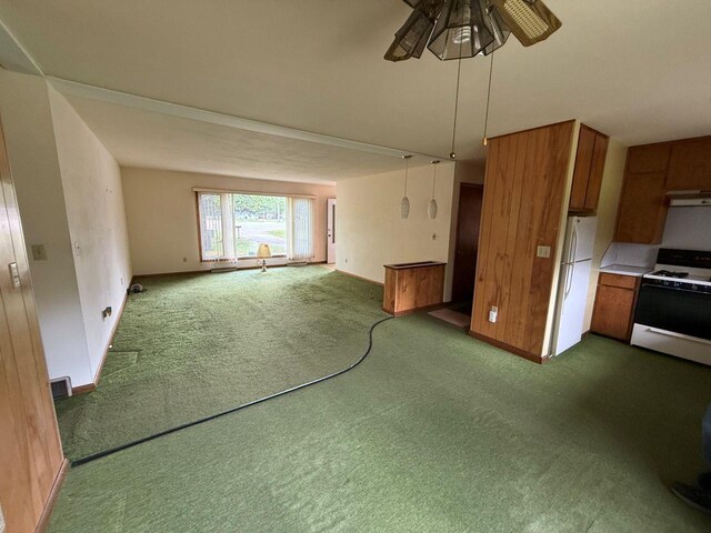 W12574 US Highway 45, Marion, WI 54950 - unfurnished living room with a ceiling fan, dark colored carpet, and baseboards