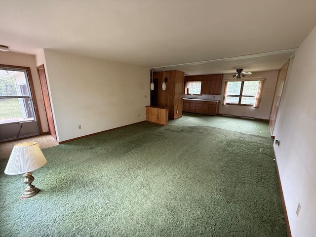 W12574 US Highway 45, Marion, WI 54950 - unfurnished living room featuring light carpet, baseboards, and a sink
