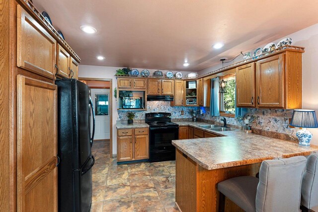 N3154 River Bend Dr, Peshtigo, WI 54157 - kitchen with black appliances, exhaust hood, a peninsula, brown cabinets, and recessed lighting