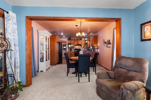 N3154 River Bend Dr, Peshtigo, WI 54157 - dining area with a chandelier, light colored carpet, and baseboards