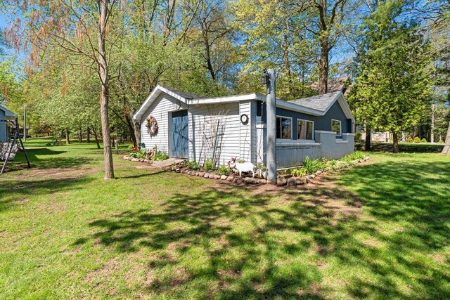 N3154 River Bend Dr, Peshtigo, WI 54157 - view of property exterior with a lawn and an outdoor structure