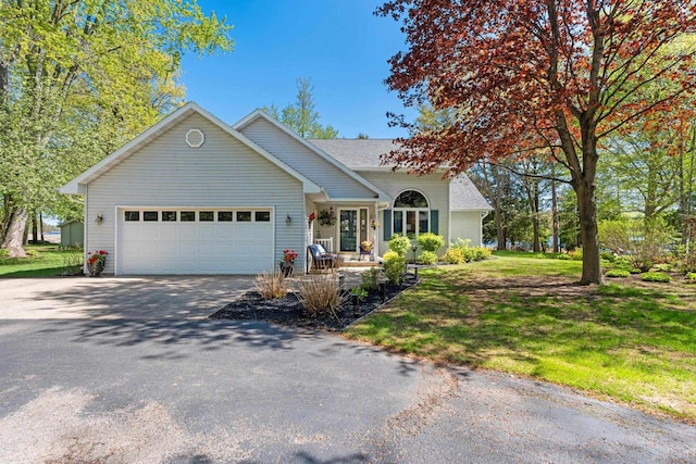 N3154 River Bend Dr, Peshtigo, WI 54157 - ranch-style home with driveway, a garage, a front lawn, and a porch