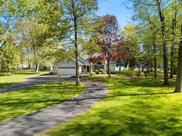 N3154 River Bend Dr, Peshtigo, WI 54157 - view of property hidden behind natural elements with driveway, an attached garage, and a front yard