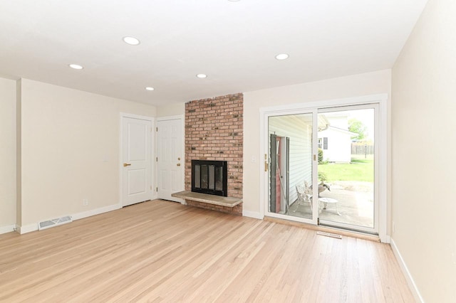 9530 W Debbie Ln, Milwaukee, WI 53224 - unfurnished living room featuring light wood-style flooring, baseboards, a fireplace, and recessed lighting