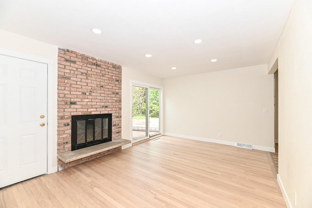 9530 W Debbie Ln, Milwaukee, WI 53224 - unfurnished living room with light wood-style floors, a brick fireplace, baseboards, and recessed lighting